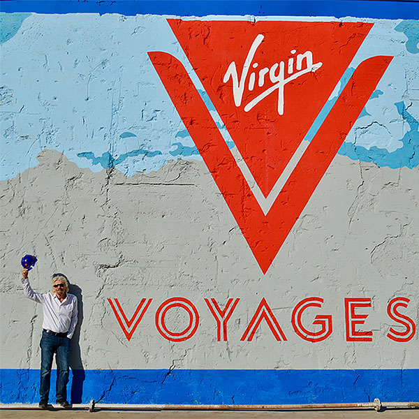 richard brandon in front of virgin voyages logo